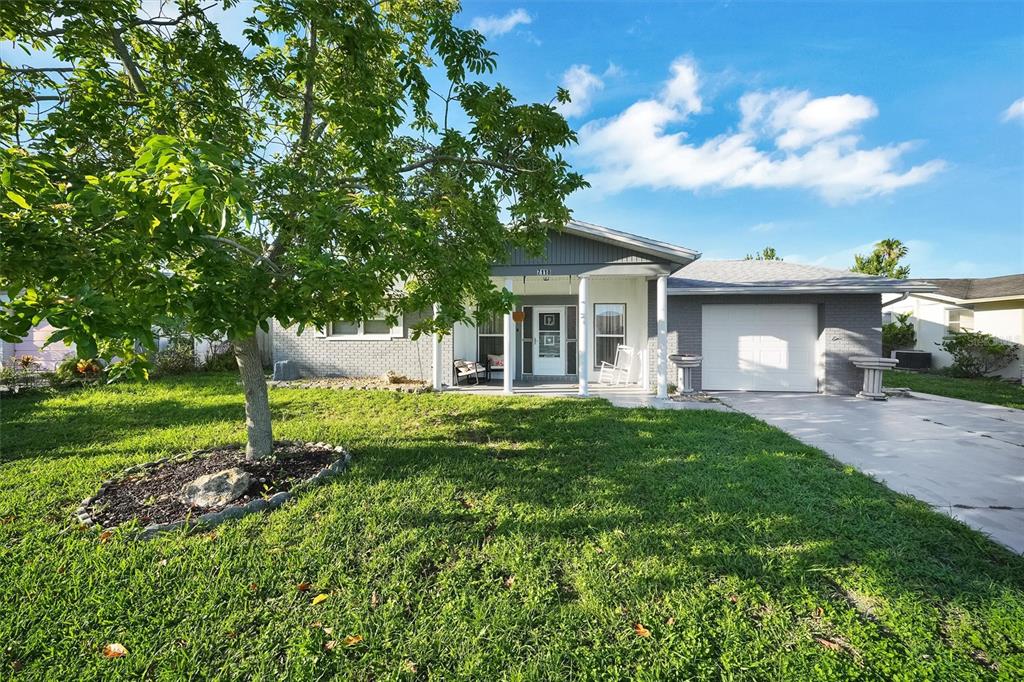 7118 Cherry Laurel Drive Port Richey, FL 34668 - Photo 1 of 1 a view of a house with a yard and tree s