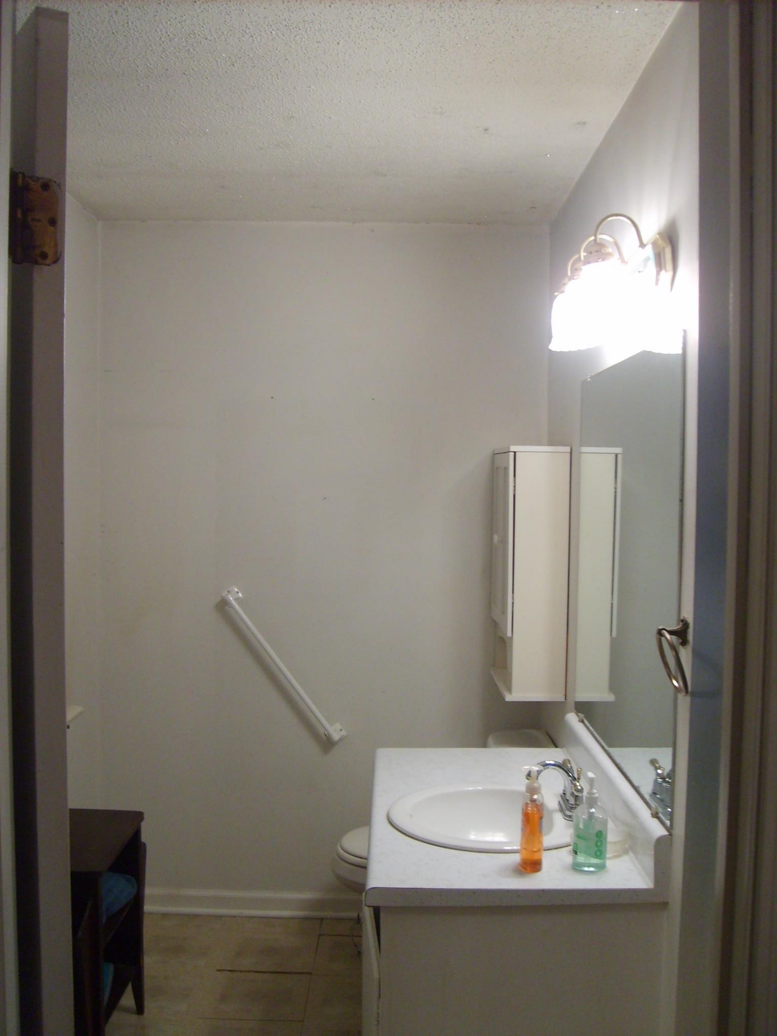 605 Blue Bonnett Road Bolivar, TN 38008 - Photo 14 of 18 a bathroom with a sink and a mirror