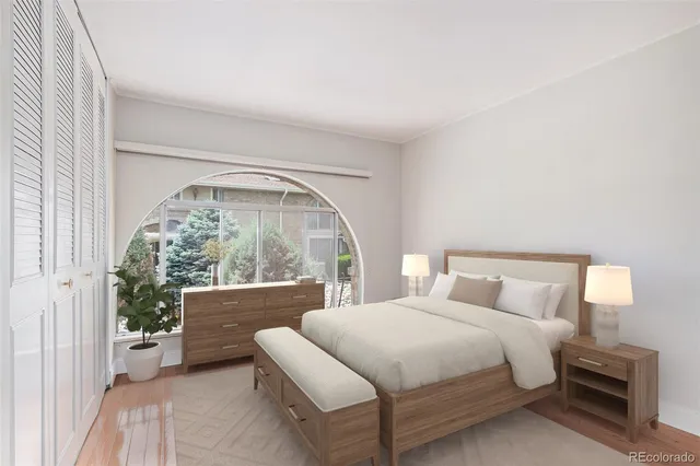a bedroom with a bed and a large window