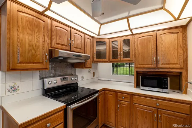 a kitchen with stainless steel appliances granite countertop a stove and a refrigerator