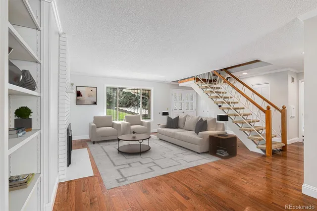 a living room with furniture and a wooden floor