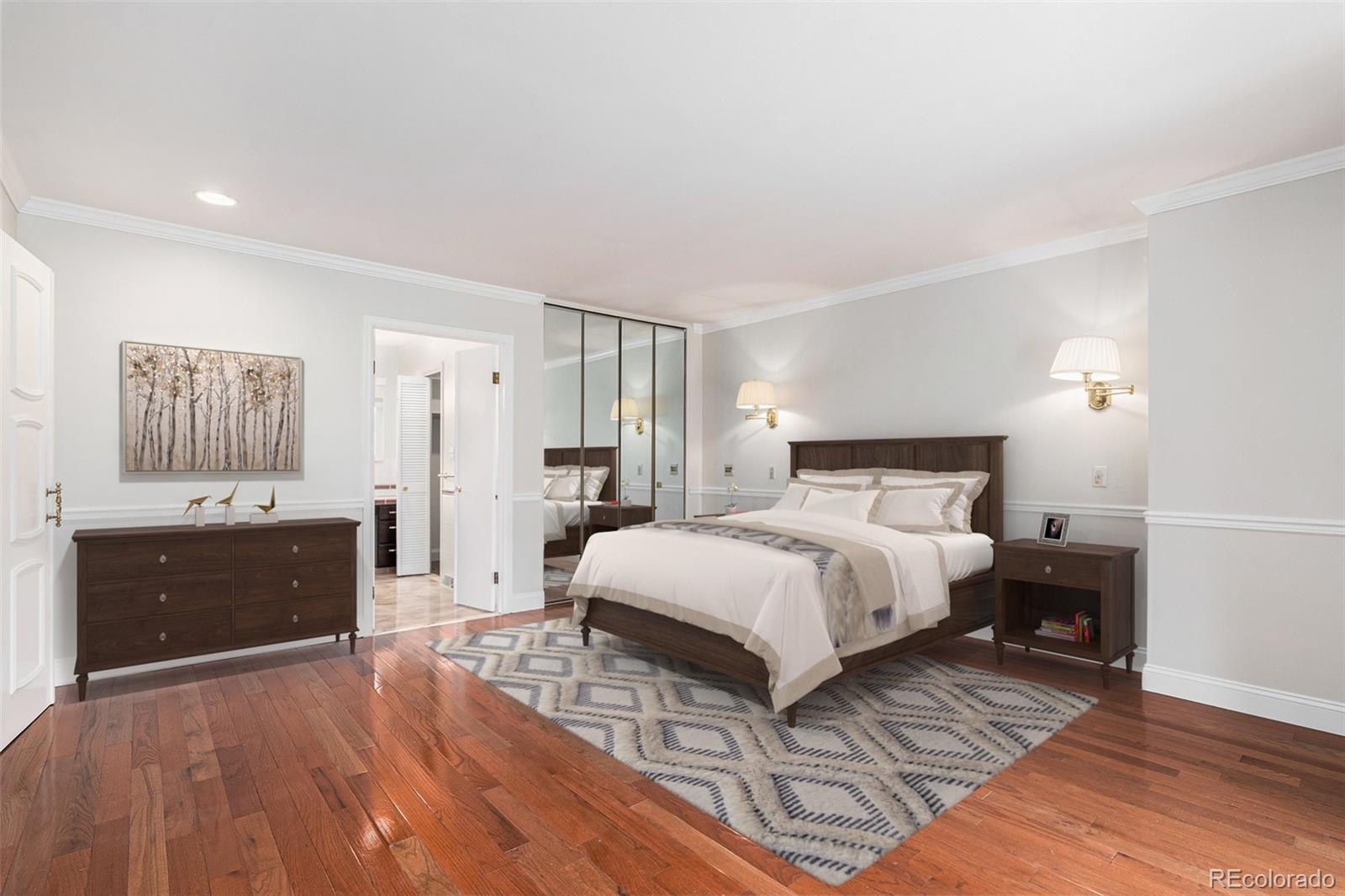 3210 South Oneida Way Denver, CO 80224 - Photo 7 of 28 a bedroom with a bed and wooden floor