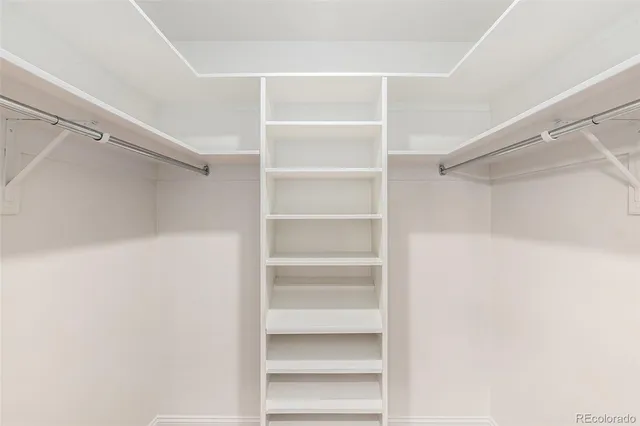 a view of walk in closet with empty racks