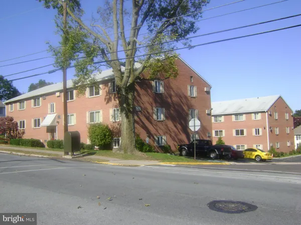 a view of a street with a building in the background