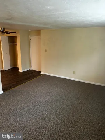 a view of an empty room and wooden floor