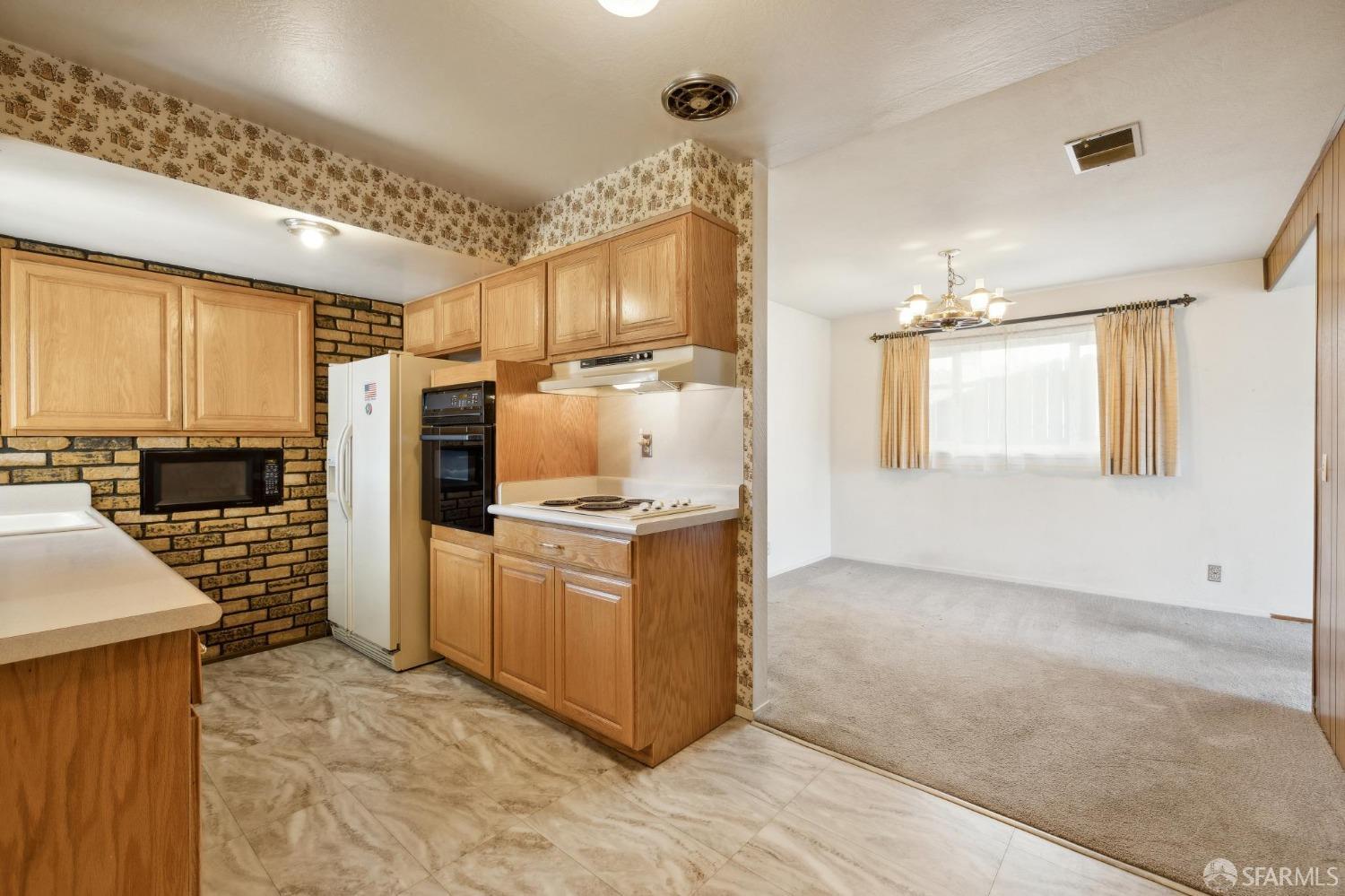 2521 Sherwood Drive San Bruno, CA 94066 - Photo 15 of 39 a kitchen with stainless steel appliances granite countertop a refrigerator a stove and a sink