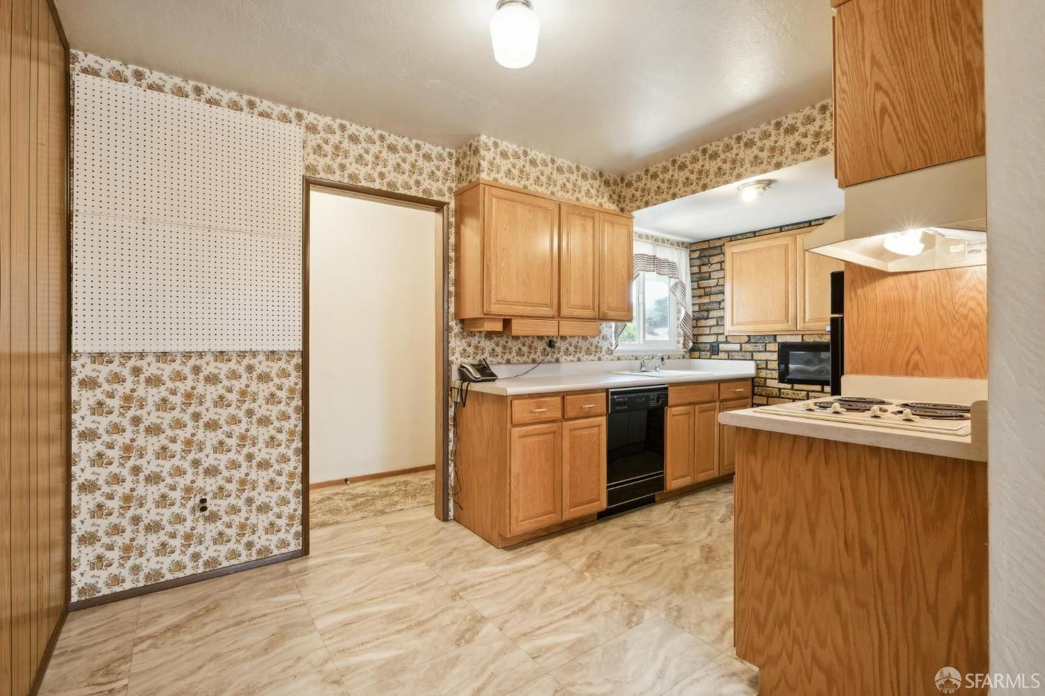 2521 Sherwood Drive San Bruno, CA 94066 - Photo 18 of 39 a kitchen with kitchen island granite countertop a sink appliances cabinets and a counter top space