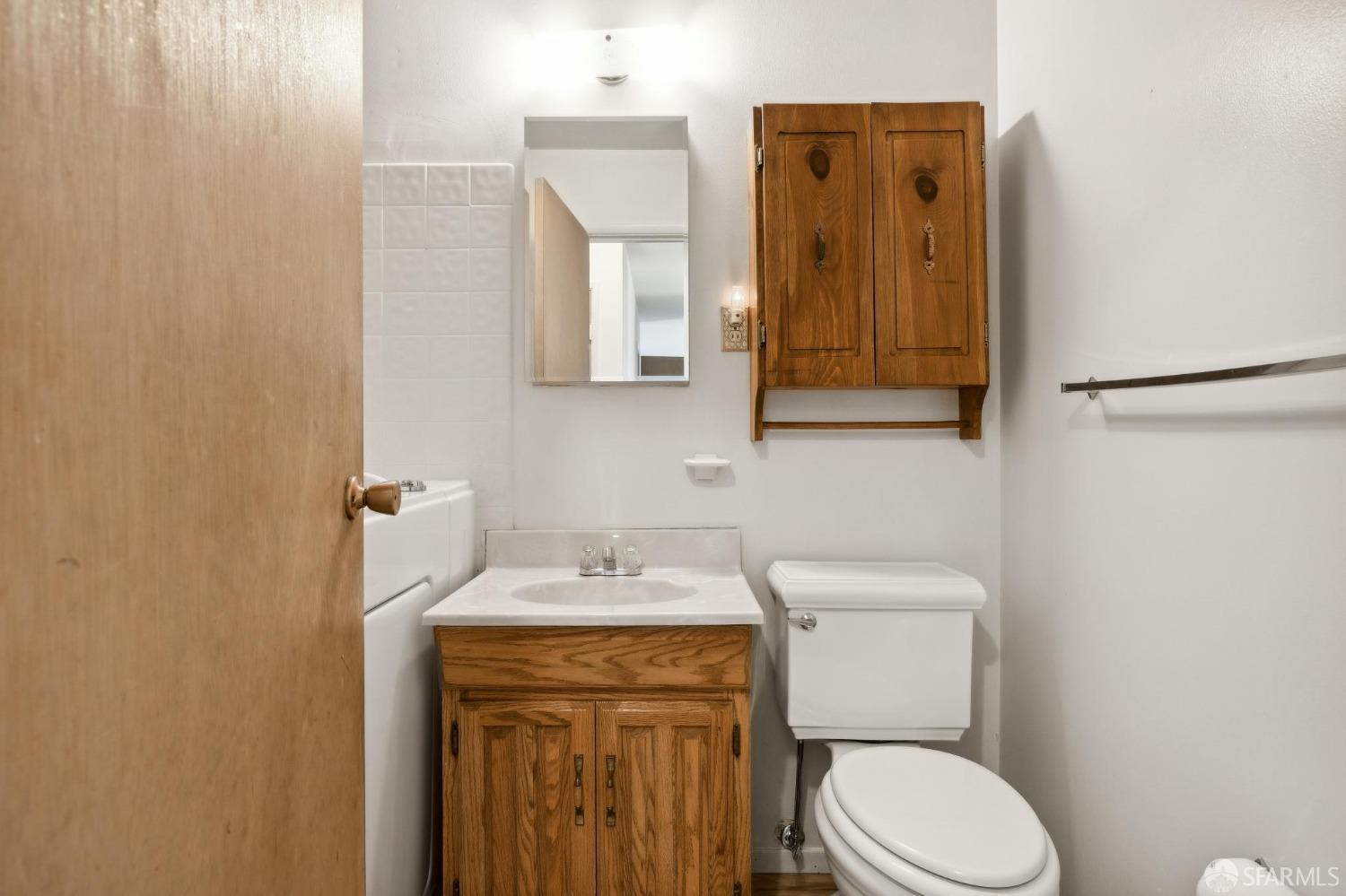 2521 Sherwood Drive San Bruno, CA 94066 - Photo 26 of 39 a bathroom with a toilet sink vanity and mirror