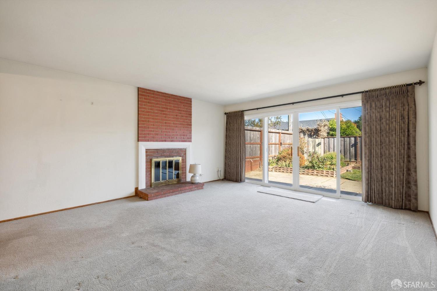 2521 Sherwood Drive San Bruno, CA 94066 - Photo 6 of 39 a view of an empty room with a fireplace and a window