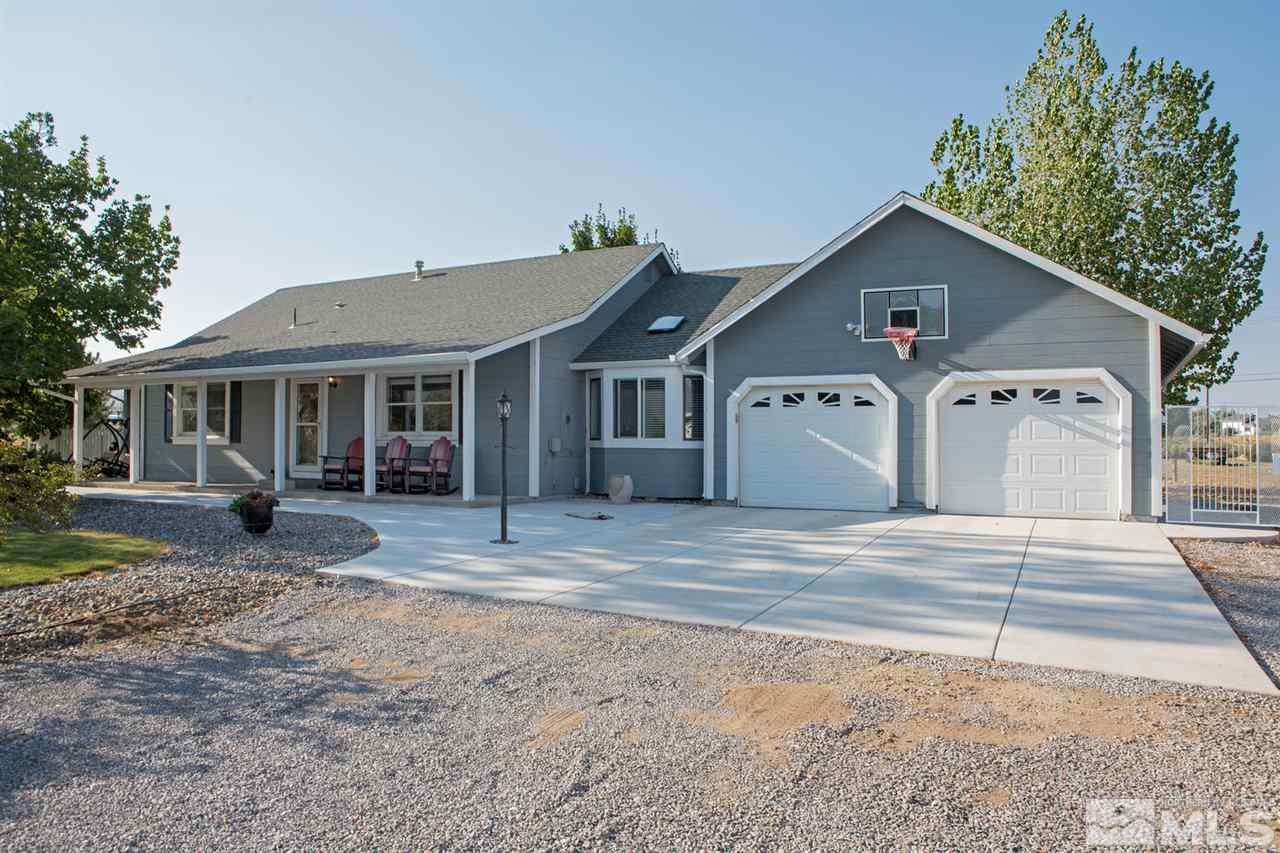 10785 Santa Fe Road Reno, NV 89508 - Photo 1 of 25 a front view of a house with a yard and garage