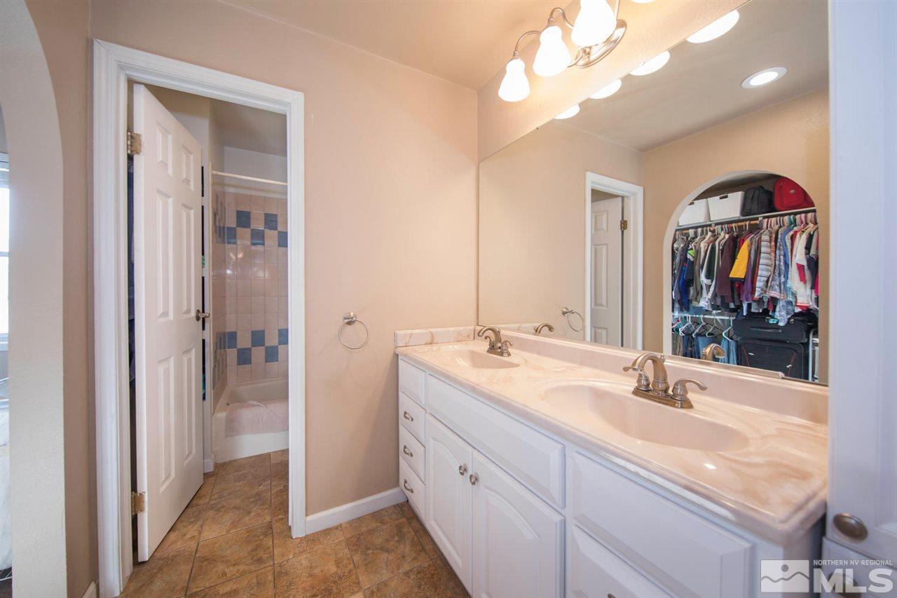 10785 Santa Fe Road Reno, NV 89508 - Photo 11 of 25 a en suite bathroom with a double vanity sink and a mirror
