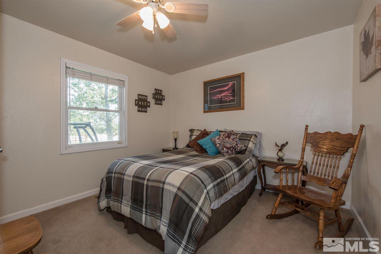 10785 Santa Fe Road Reno, NV 89508 - Photo 12 of 25 a bed room with a bed and a chair