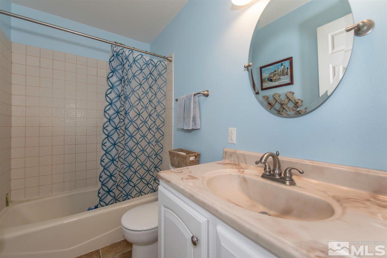 10785 Santa Fe Road Reno, NV 89508 - Photo 14 of 25 a bathroom with a sink a toilet and a mirror