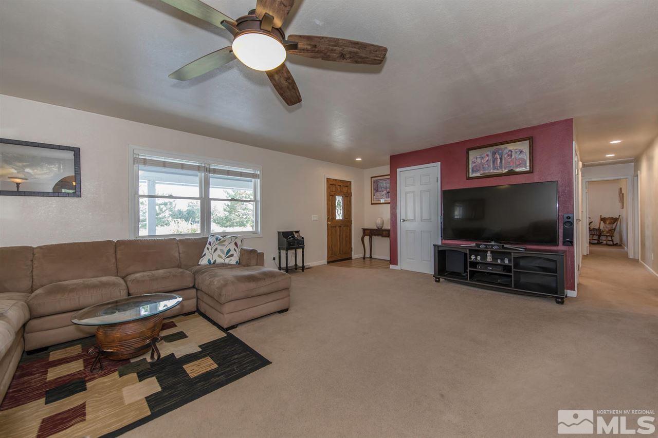 10785 Santa Fe Road Reno, NV 89508 - Photo 2 of 25 a living room with furniture and a flat screen tv