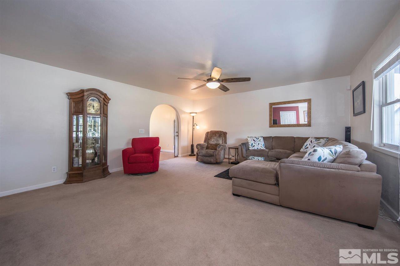 10785 Santa Fe Road Reno, NV 89508 - Photo 3 of 25 a living room with furniture and a chandelier