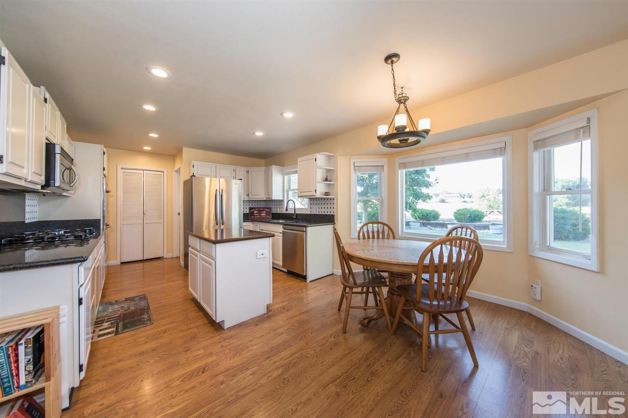 10785 Santa Fe Road Reno, NV 89508 - Photo 4 of 25 a dining room with furniture and wooden floor