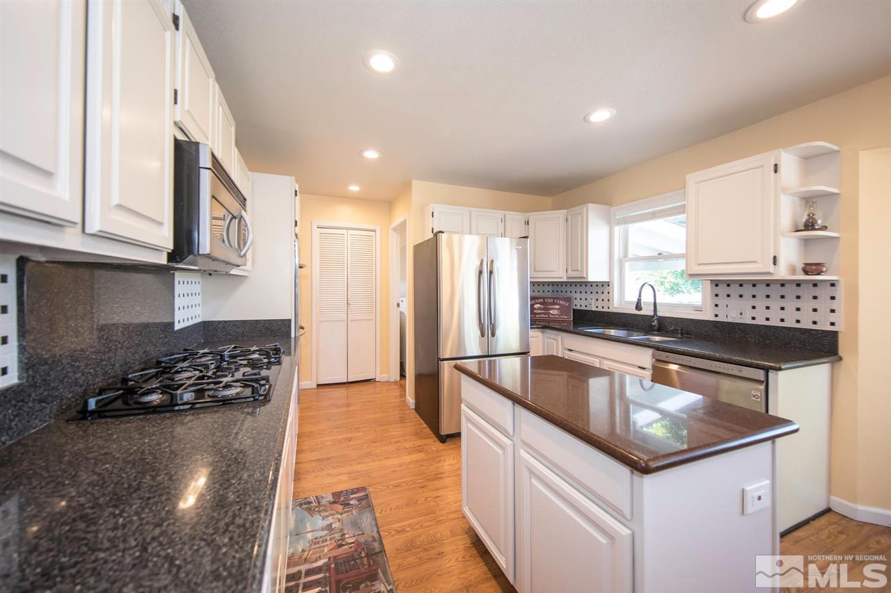 10785 Santa Fe Road Reno, NV 89508 - Photo 5 of 25 a kitchen with stainless steel appliances granite countertop a sink stove and refrigerator