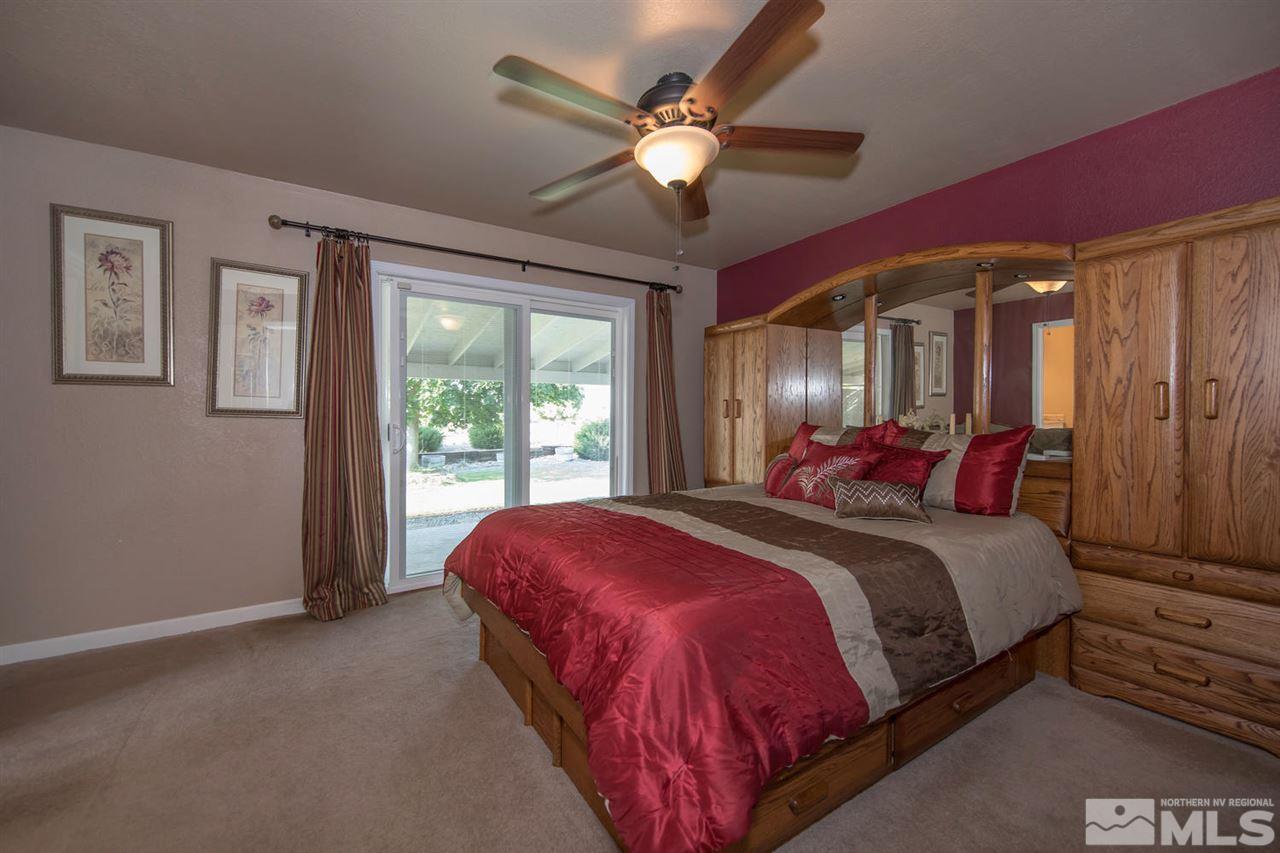 10785 Santa Fe Road Reno, NV 89508 - Photo 10 of 25 a bed sitting in a spacious bedroom next to a window