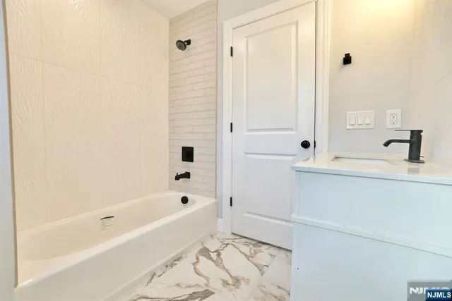 a bathroom with a bathtub and a shower