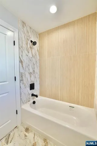 a bathroom with a bathtub and a shower