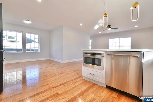 a view of a kitchen with a sink and microwave