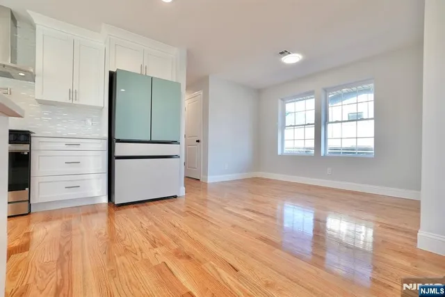 a view of a kitchen with wooden floor