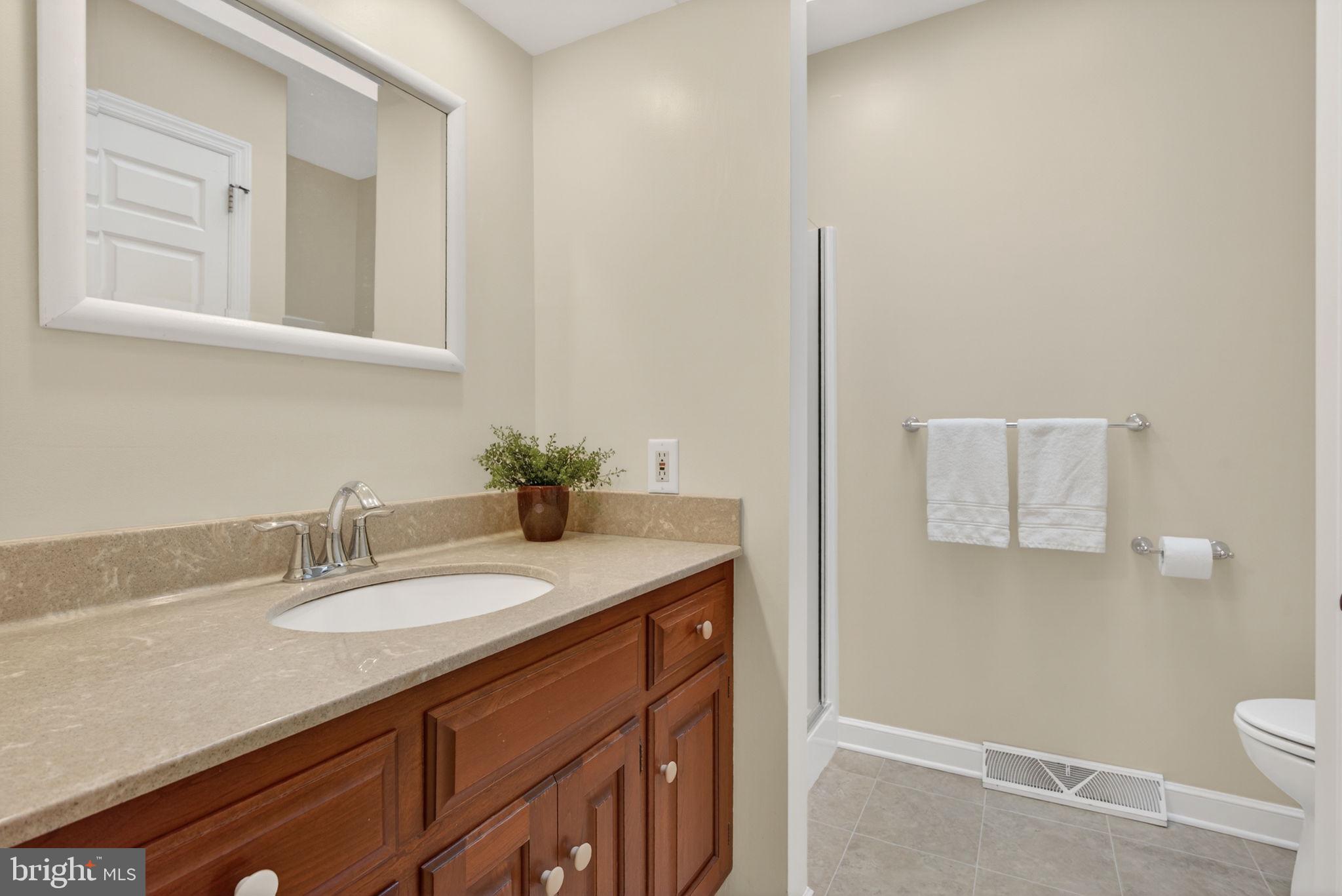 816 Tarpley Drive Lancaster, PA 17601 - Photo 37 of 110 a bathroom with a granite countertop sink a toilet and a mirror
