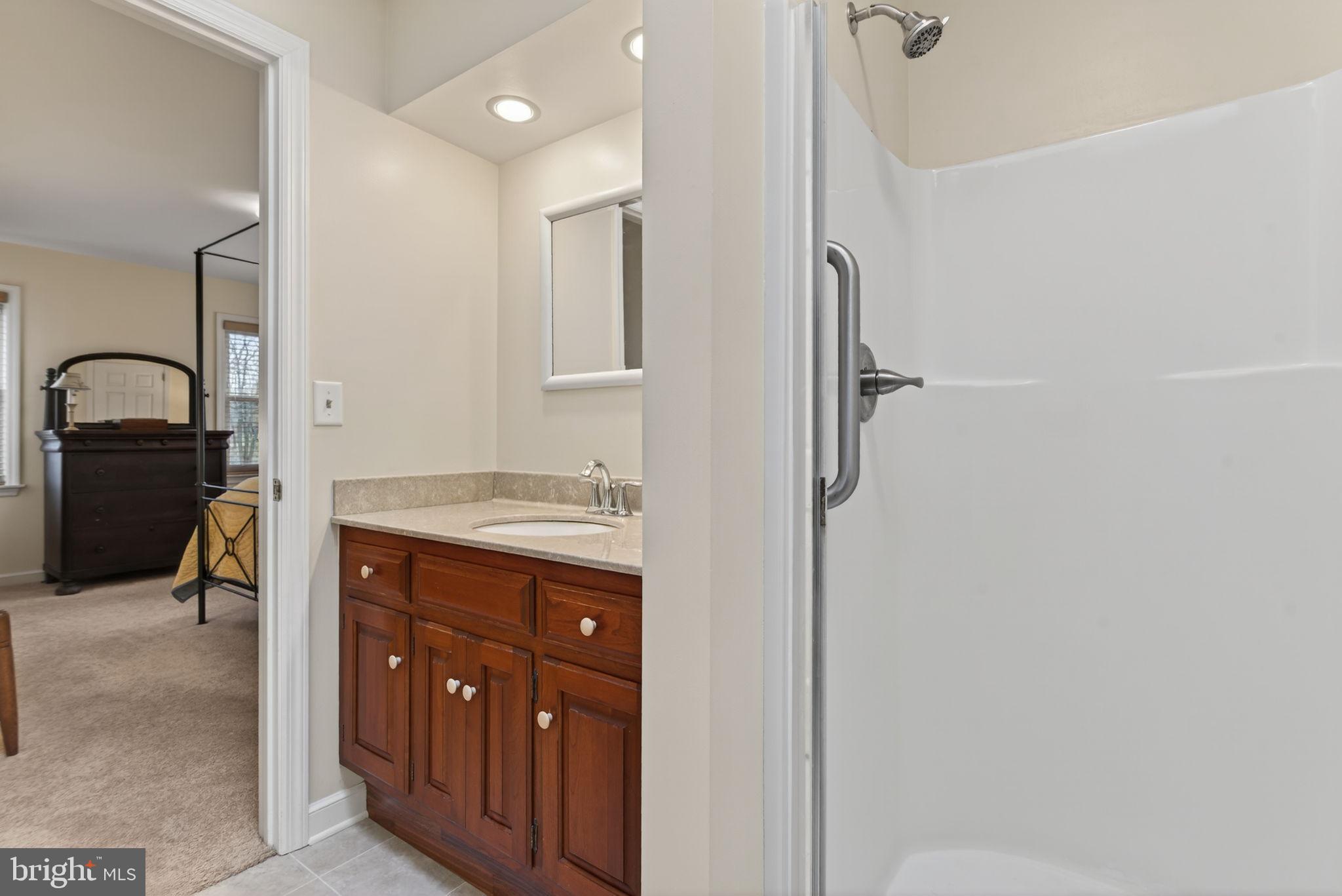 816 Tarpley Drive Lancaster, PA 17601 - Photo 38 of 110 a en suite bathroom with a granite countertop sink a mirror and shower