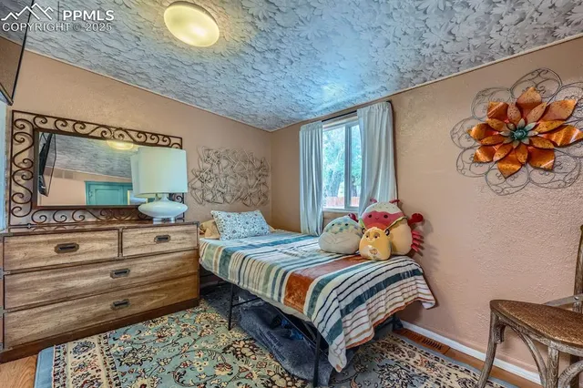 a bedroom with a bed and dresser