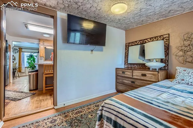 a bedroom with bed and flat screen tv