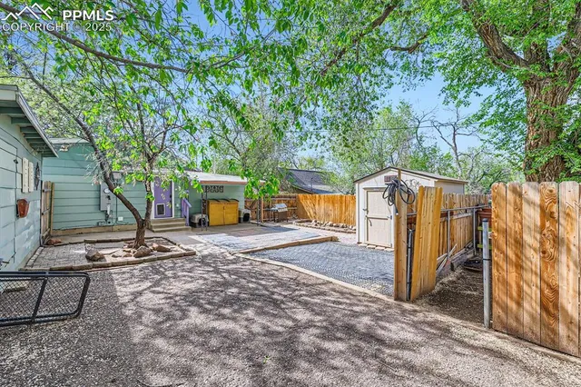 a view of a park with iron fence