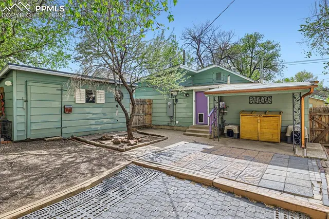 a view of a house with a patio and a yard