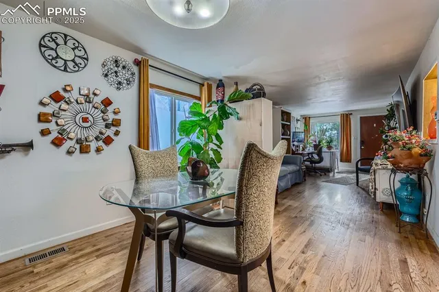 a view of a dining room with furniture and a potted plant