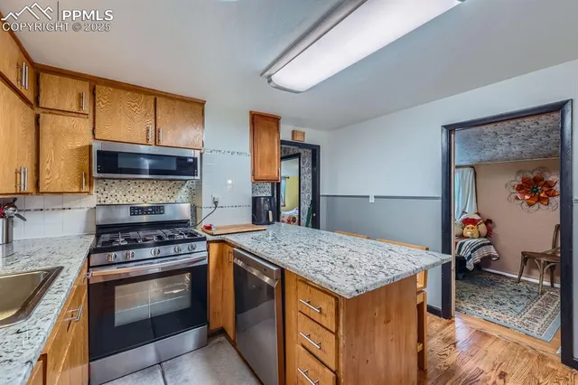 a kitchen with granite countertop a stove and a sink