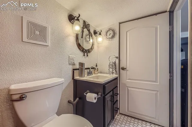 a bathroom with a toilet a sink and a mirror