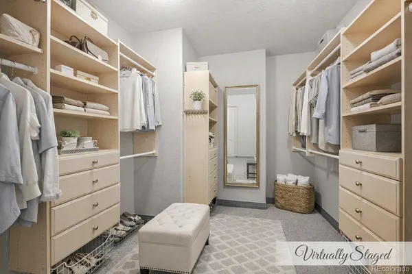 a bedroom with a bed couch and large window