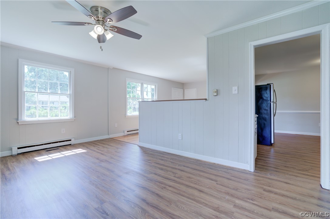 1510 Schloss Road Richmond, VA 23225 - Photo 6 of 28 an empty room with wooden floor chandelier fan and windows