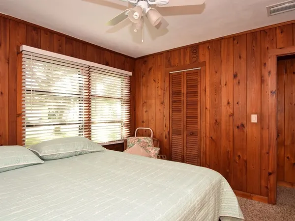 a bedroom with a large bed and a window