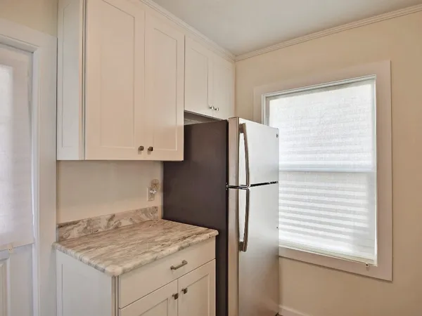 a kitchen with a refrigerator and cabinets