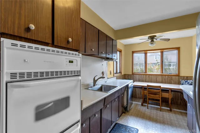 a kitchen with granite countertop a stove a sink and a microwave oven