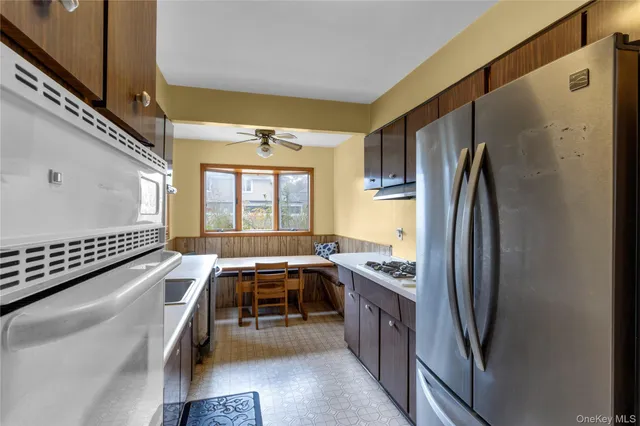 a kitchen with stainless steel appliances granite countertop a refrigerator and a sink