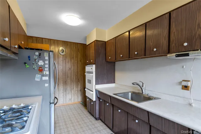 a kitchen with stainless steel appliances granite countertop a sink stove and cabinets