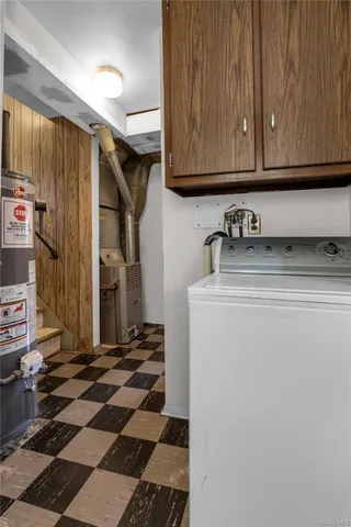 a view of a big white house with a big yard and large trees