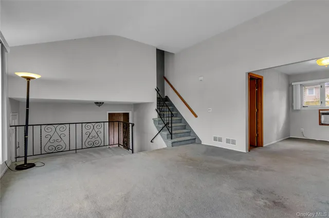 a view of an empty room with stairs