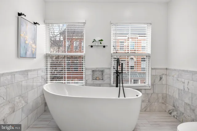 a bathroom with a sink toilet a mirror and shower
