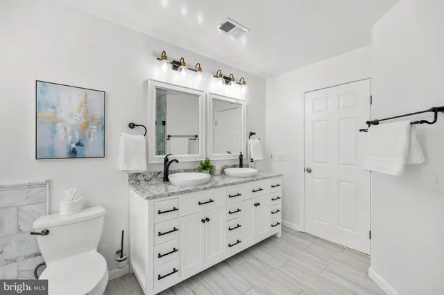 an empty room with a fireplace and windows