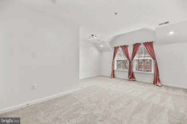 a view of a house with a big yard and large trees
