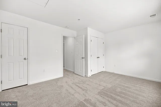 an aerial view of residential houses with outdoor space and lake view