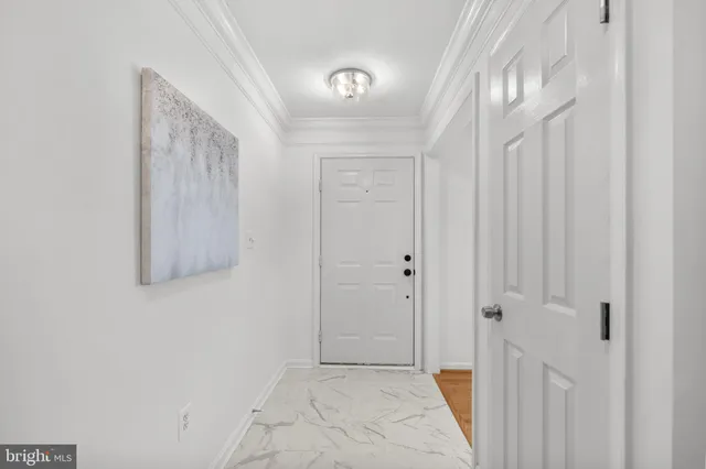 a view of a dining room with furniture a chandelier and wooden floor