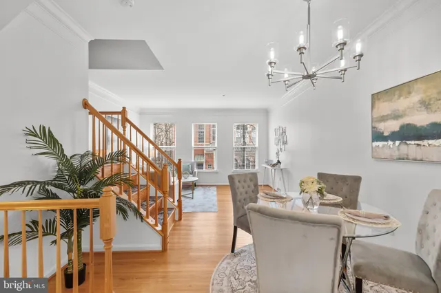 a living room with furniture or couch and a dining table with wooden floor
